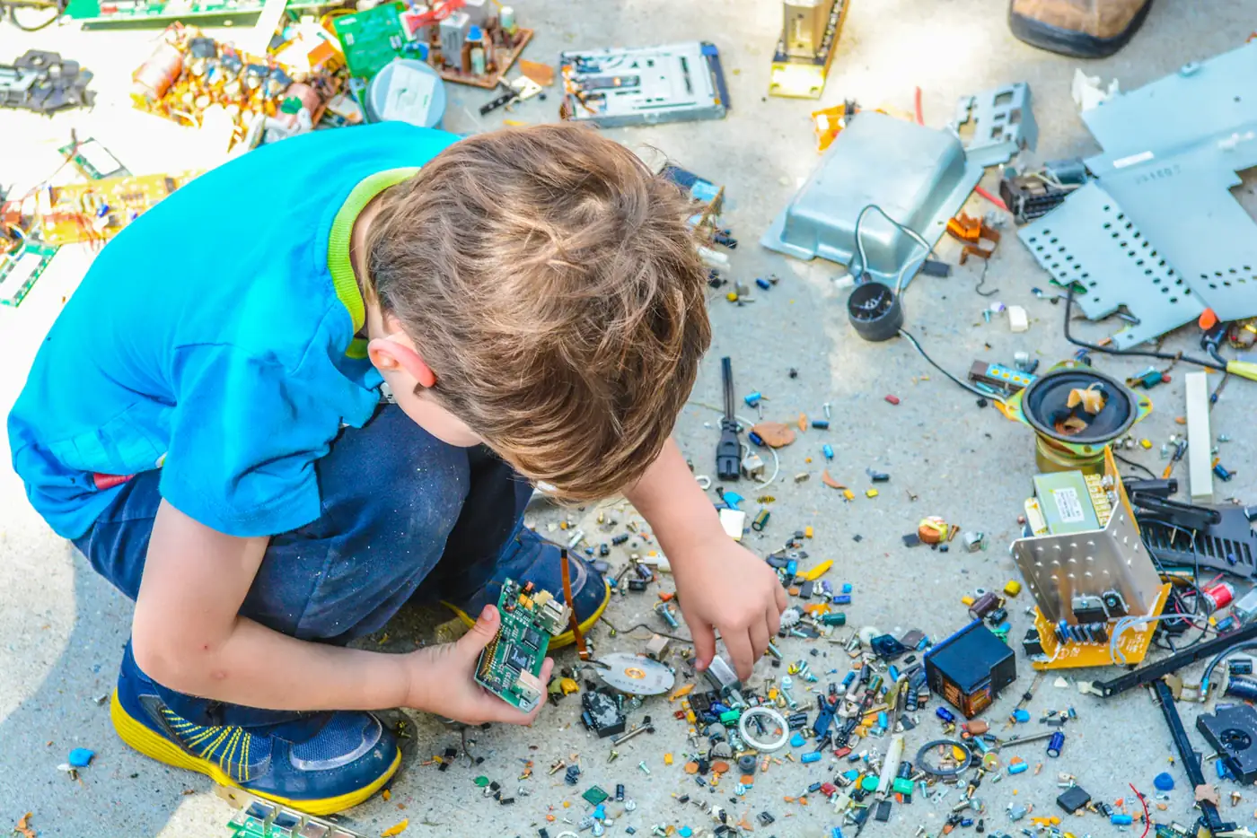 A young child building with toy bricks on the floor
