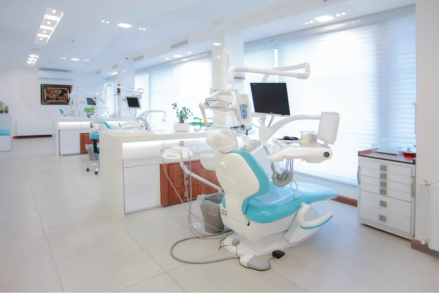 Bright treatment room with a teal chair