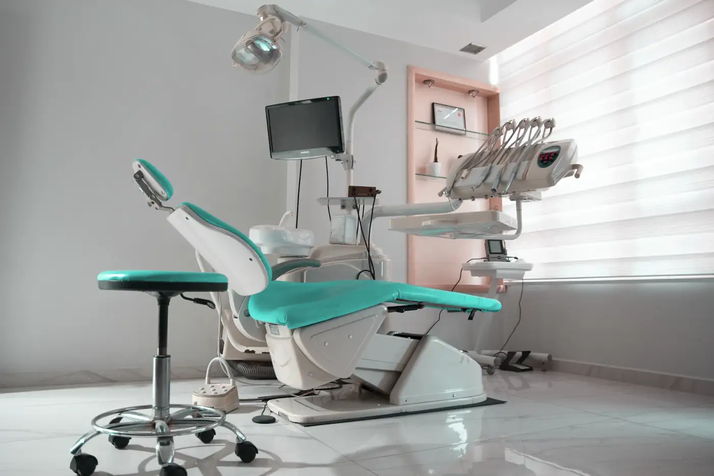 Dental chair with teal and pink details