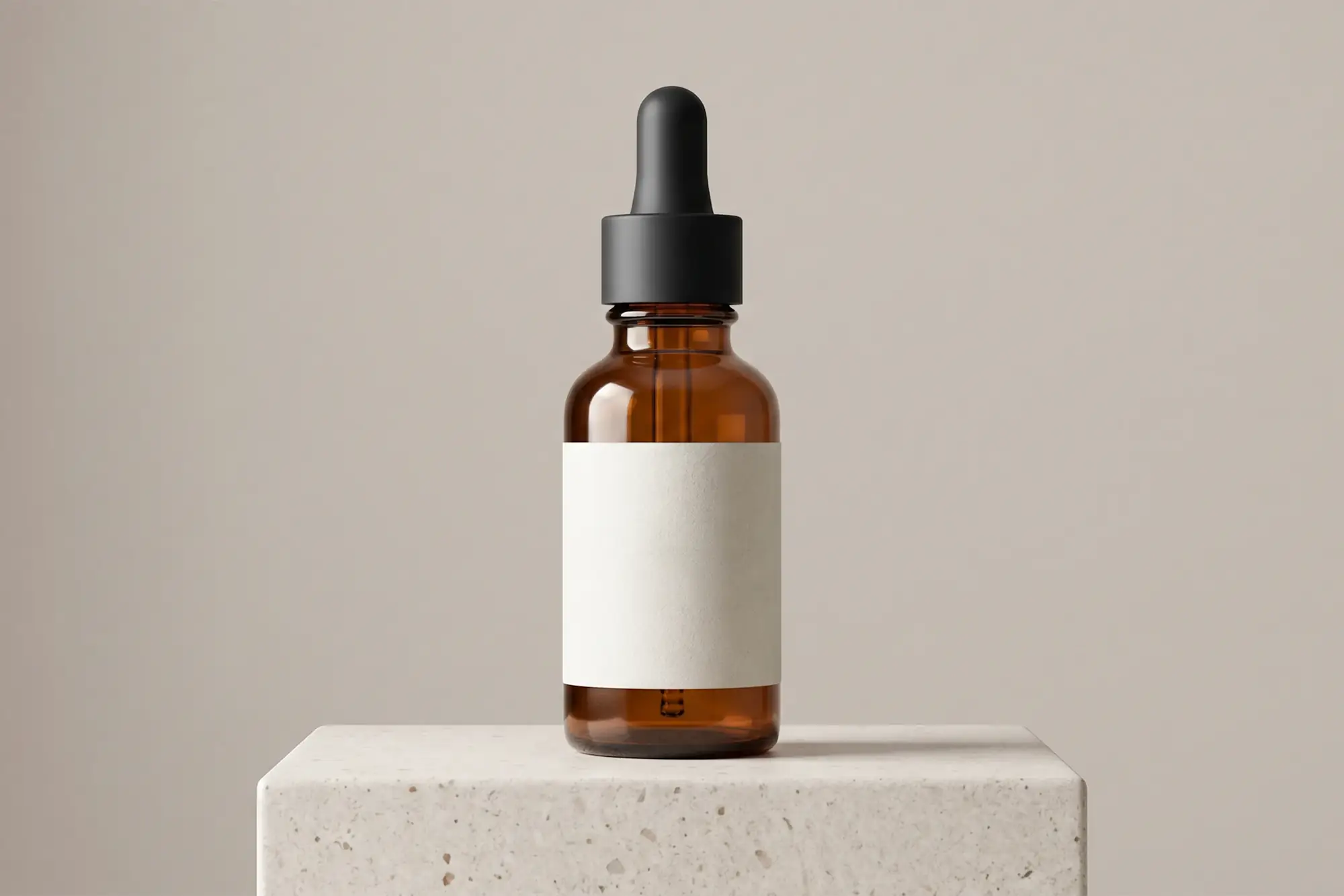 Amber dropper bottle standing on a stone plinth