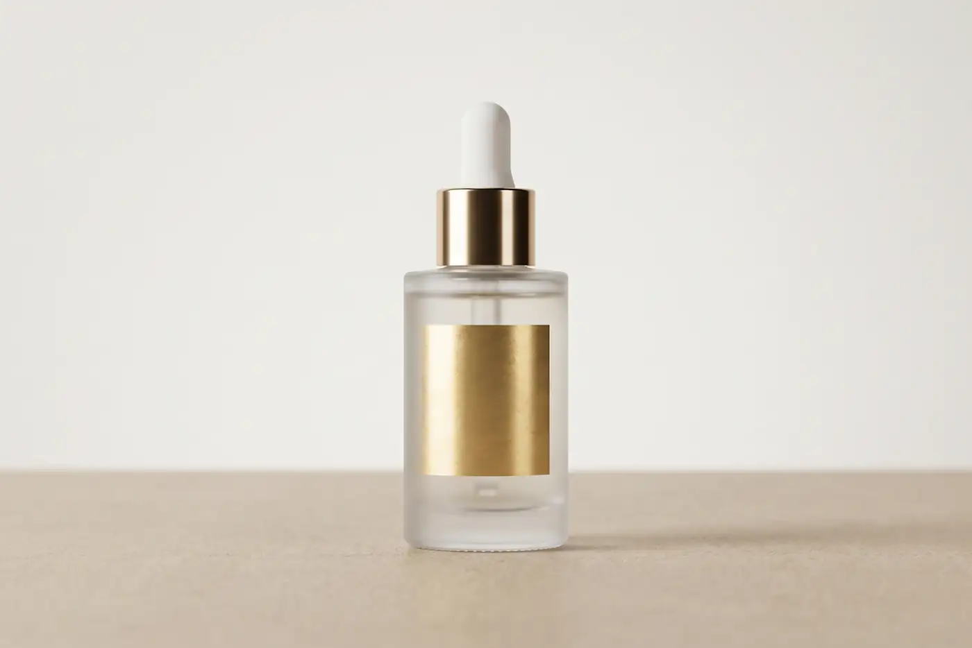 Frosted glass bottle with a gold label on a beige background