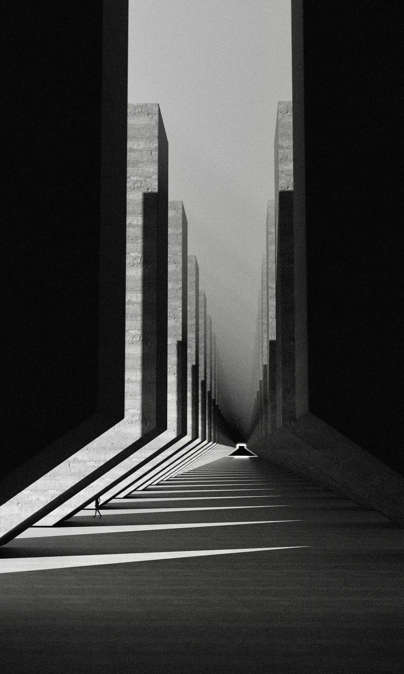 Narrow concrete corridor with sharp shadows