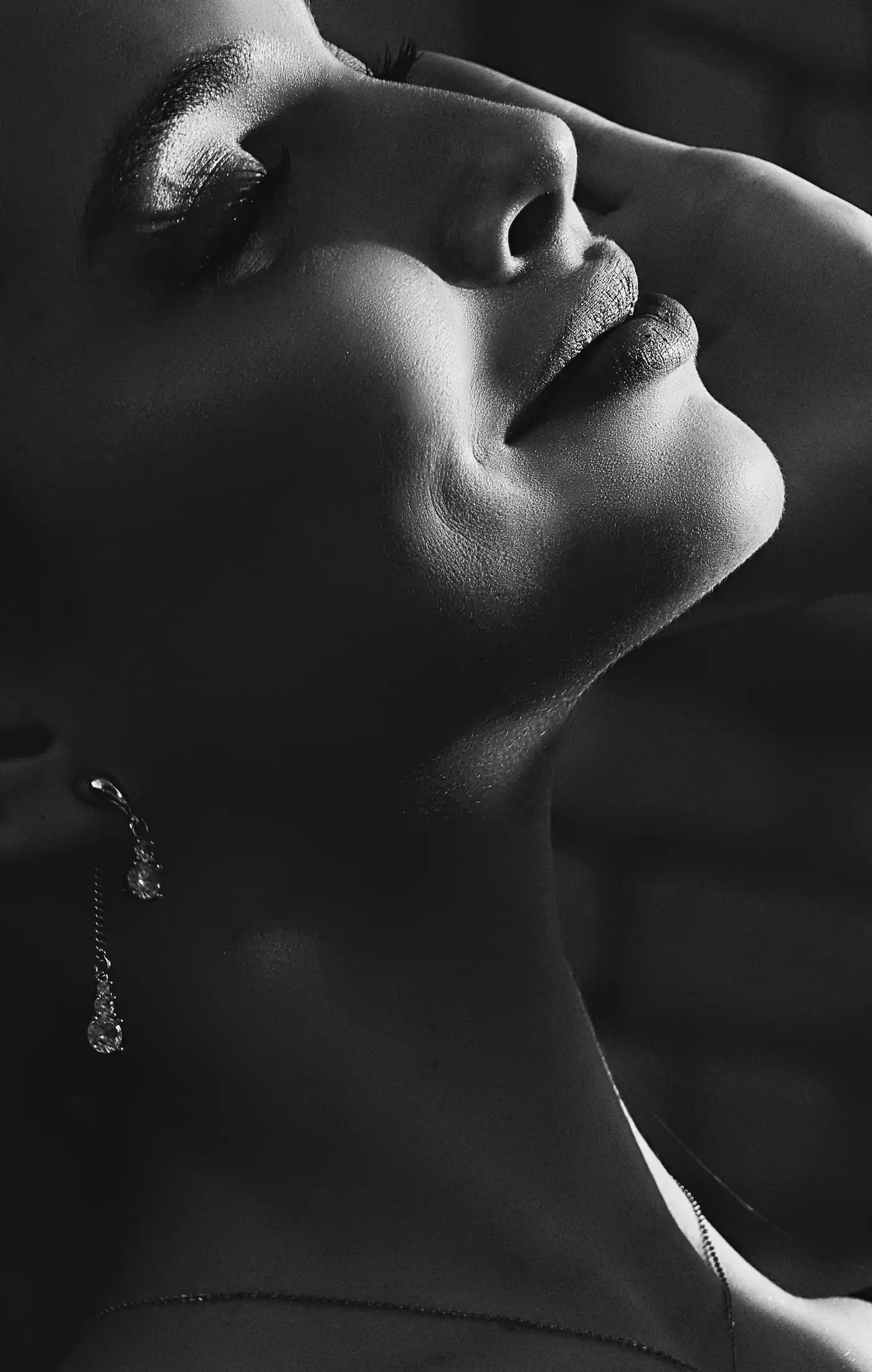Black and white profile wearing a long drop earring