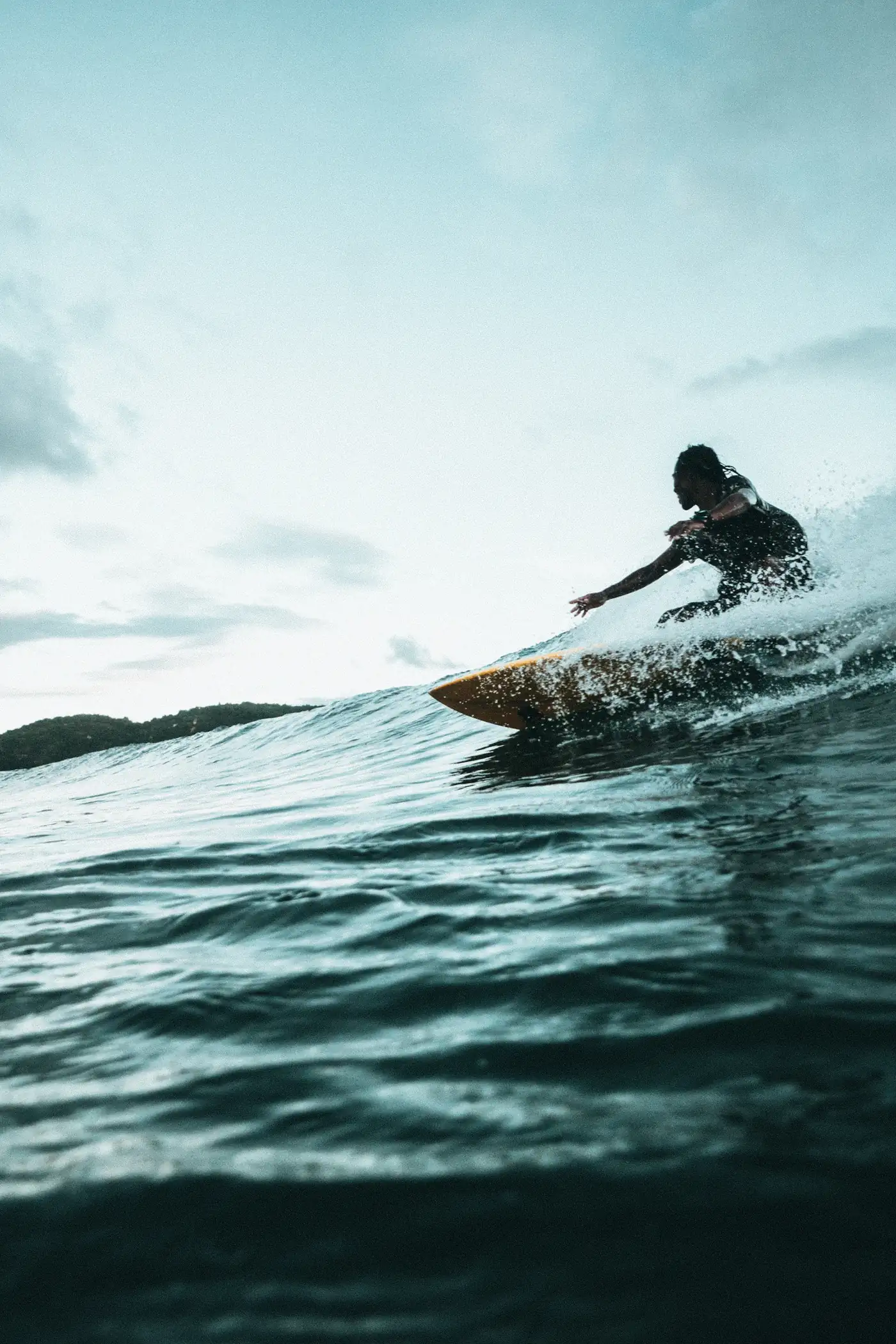 Surfer carving at golden hour