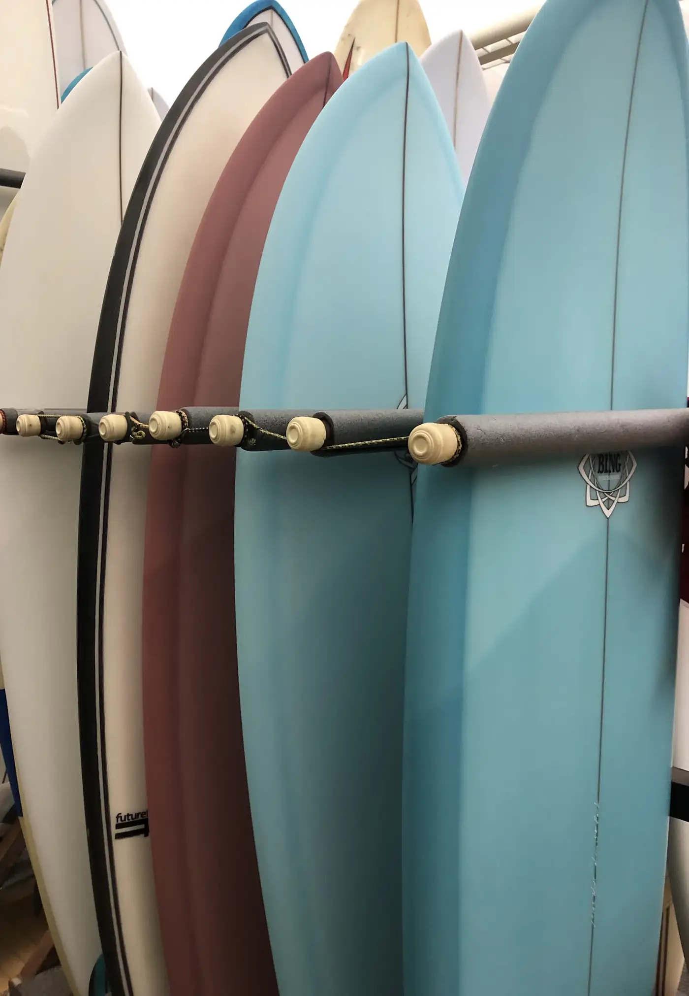 Pastel surfboards on a rack