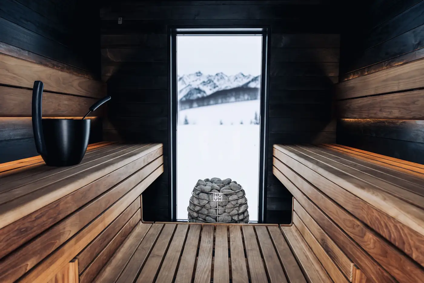 Sauna with a window looking out to snowy mountains