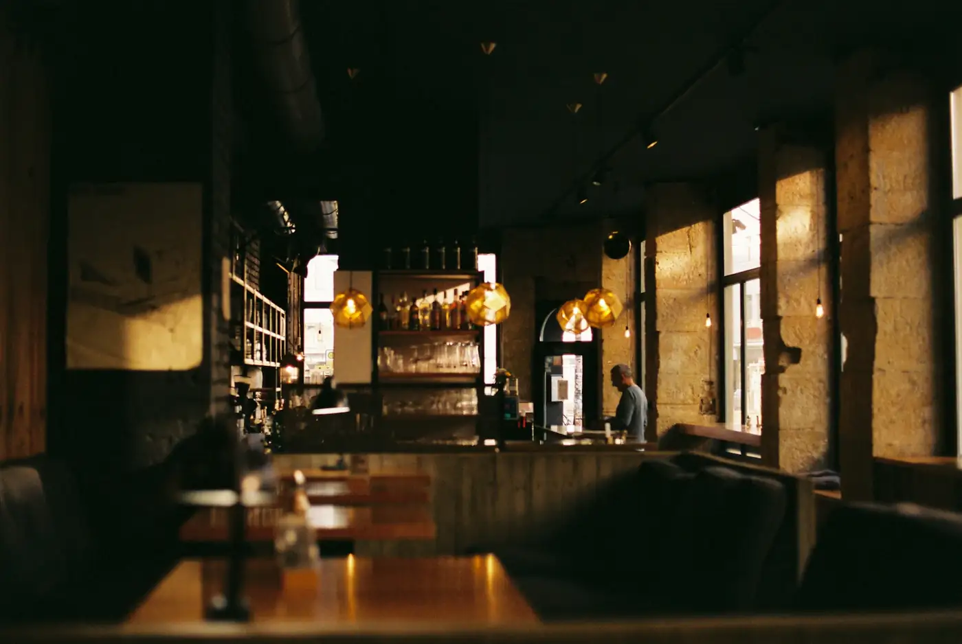 Moody restaurant room with a bar and warm lights